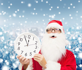 Image showing man in costume of santa claus with clock