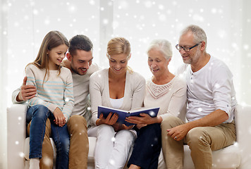 Image showing happy family with book or photo album at home