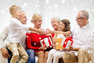 Image showing smiling family with gifts at home