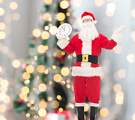 Image showing man in costume of santa claus with clock