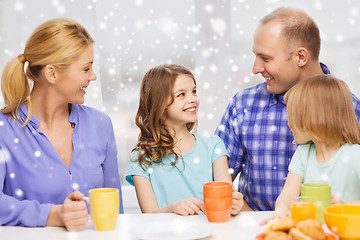 Image showing happy family with two kids having breakfast