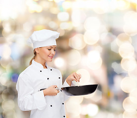 Image showing smiling female chef with pan and spoon