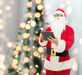 Image showing man in costume of santa claus with tablet pc