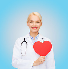 Image showing smiling female doctor with heart and stethoscope