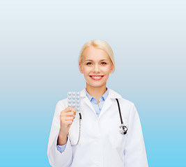 Image showing smiling female doctor with pills