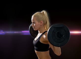 Image showing sporty woman exercising with barbell