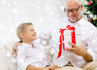 Image showing smiling grandfather and grandson at home