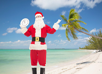 Image showing man in costume of santa claus with clock