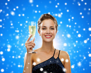 Image showing smiling woman holding glass of sparkling wine