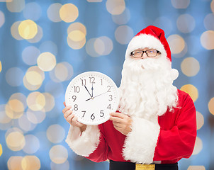 Image showing man in costume of santa claus with clock