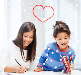 Image showing mother and daughter with coloring pencils indoors