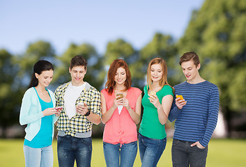 Image showing smiling students with smartphones