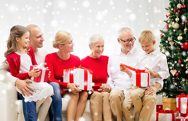 Image showing smiling family with gifts at home