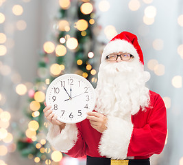 Image showing man in costume of santa claus with clock