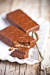 Image showing dark chocolate cakes and spoon on a plate 