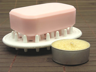 Image showing Pink soap with tea light on a  brown background