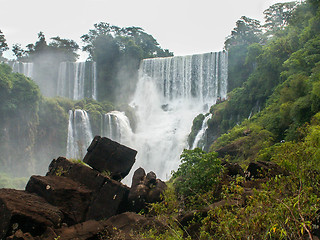 Image showing Iguazu Falls Framed By Rocks And Foliage