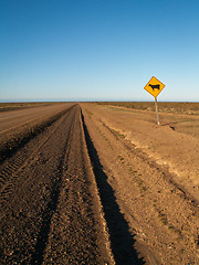 Image showing Endless Dirt Road With Cow Sign