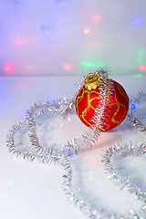 Image showing Red Christmas-tree ball and tinsel