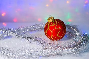 Image showing Red Christmas-tree ball and tinsel