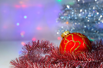 Image showing Red Christmas ball under the tree and tinsel