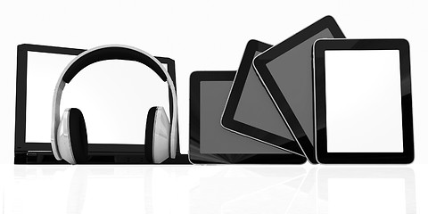 Image showing headphones on the  laptop and  tablet pc