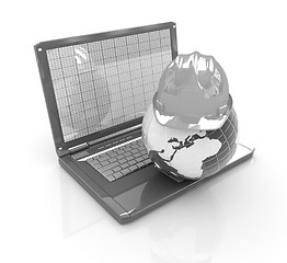 Image showing Hard hat and earth on a laptop 