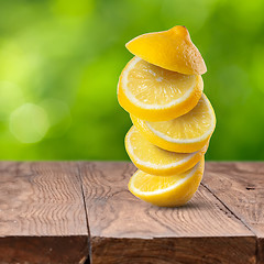 Image showing Fresh lemon cuts on wooden table