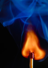 Image showing Burning match with blue smoke 