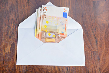 Image showing Open envelope with euro banknotes on table