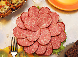 Image showing Cutting sausage