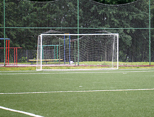 Image showing Football goal on a green field on a background