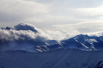 Image showing Snowy mountains in haze at sunny evening
