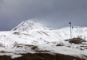 Image showing Ski slopes in little snow year at bad weather day