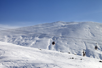 Image showing Gondola lifts and ski slope at nice sun day