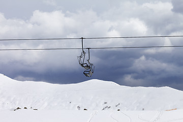 Image showing Chair lifts and off-piste slope at gray day