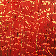 Image showing Christmas Words Pattern On Red Wooden Texture. Vector