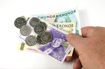Image showing Reaching over swedish money