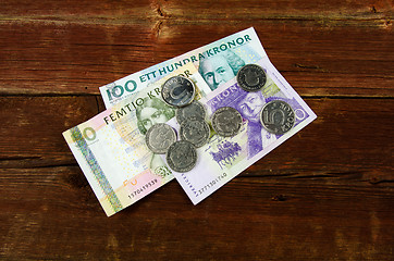 Image showing Swedish cash at an old red wooden plank