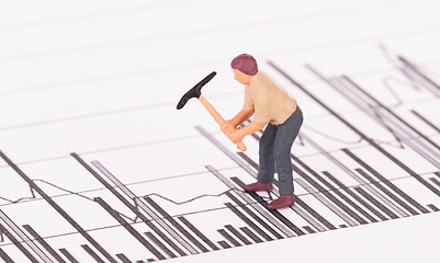 Image showing Miniature worker working on a graph