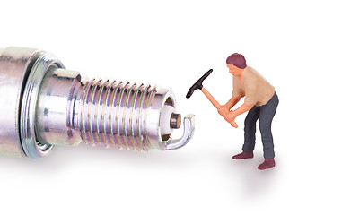 Image showing Miniature worker working on a sparkplug