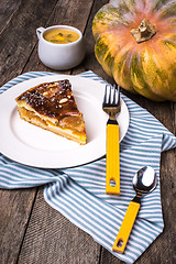 Image showing piece of Pumpkin pie with mousse on wood in Rustic style