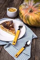 Image showing Pumpkin pie with cream soup on wooden table in Rustic style