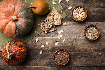 Image showing Rustic pumpkins with cookies and seeds on wood 