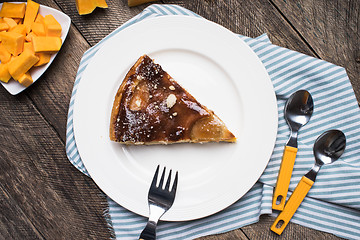 Image showing Lunch pie on plate and pieces of pumpkin in Rustic style