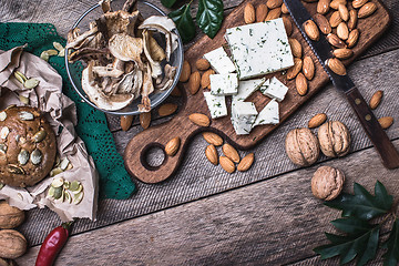 Image showing rustic style cheese with bread, cep and nuts