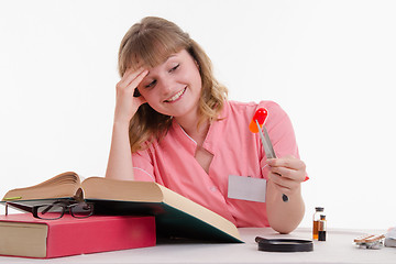 Image showing Medical student happily looking at pill