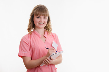 Image showing Medical practice writing in a notebook