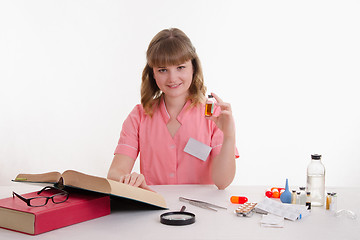 Image showing Pharmacist with an ampoule and reference