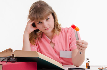 Image showing Tired student studying composition pills